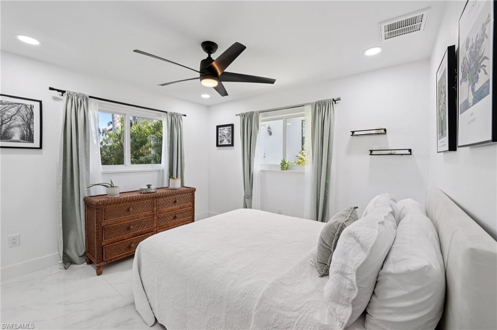 Bedroom featuring marble look tiles, a ceiling fan, and recessed lighting