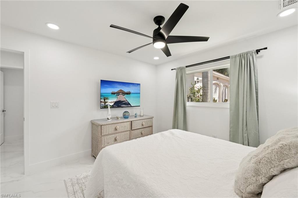 Bedroom with recessed lighting, ceiling fan, and marble finish floors
