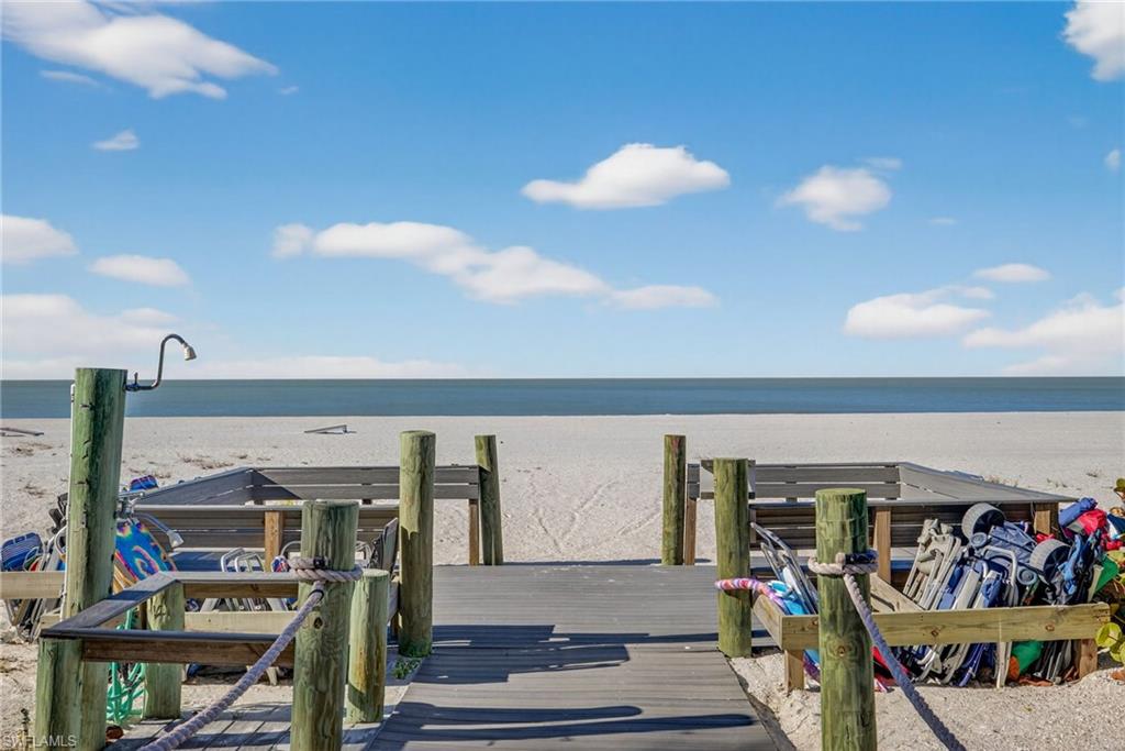 Boardwalk to beach where residents gather for cocktails at sunset.
