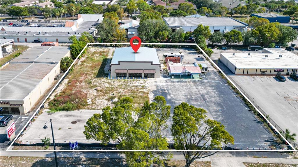 Aerial view of property and surrounding area featuring property parcel outlined