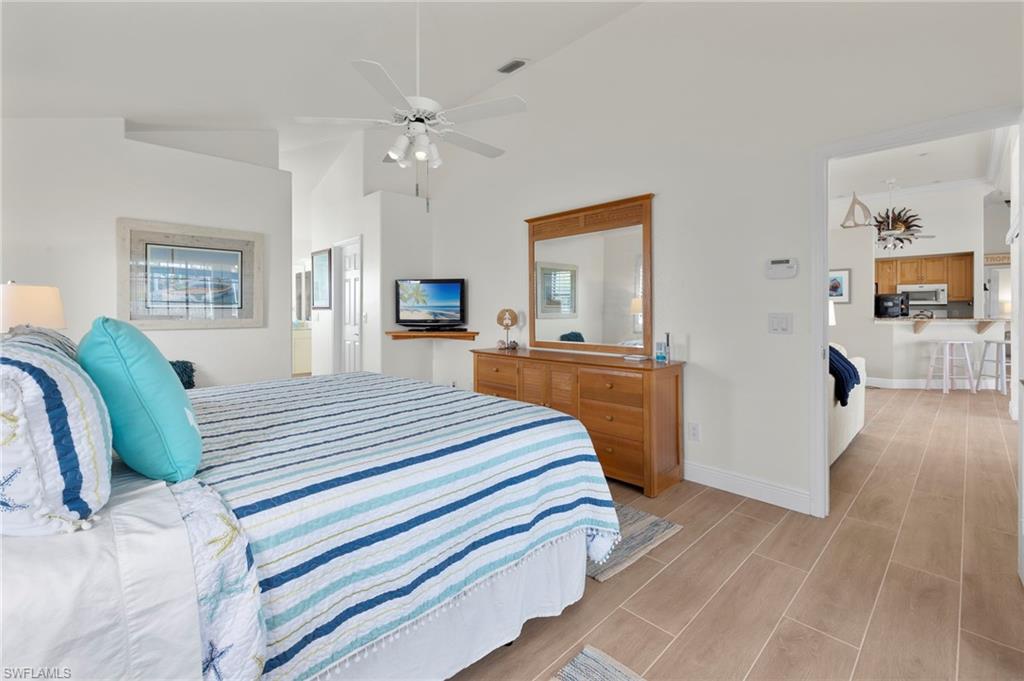 Bedroom with high vaulted ceiling and ceiling fan