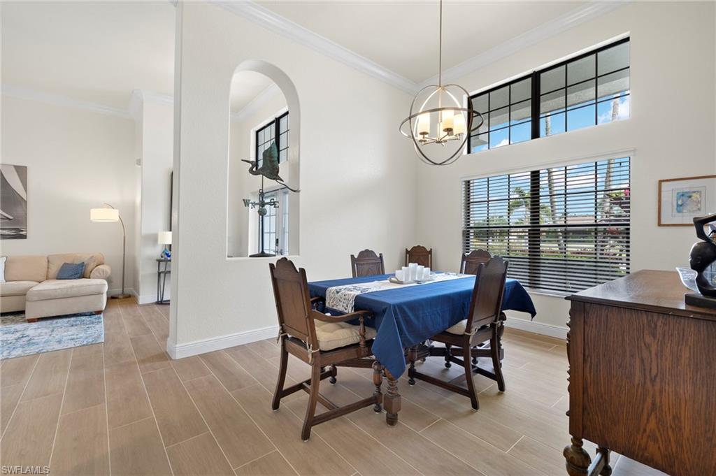 Dining room with a notable chandelier and ornamental molding
