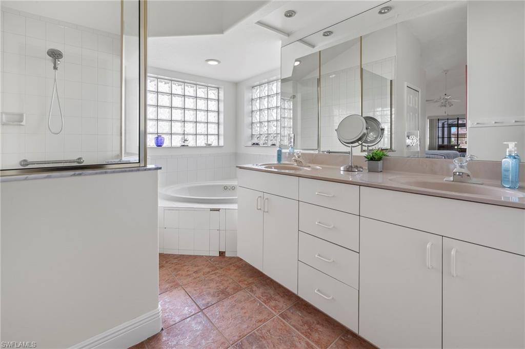 Bathroom with independent shower and bath, tile patterned flooring, and vanity