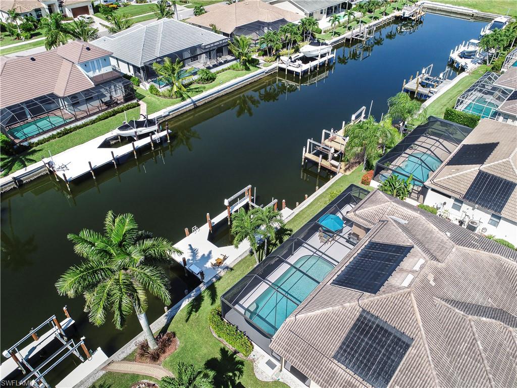 Birds eye view of property with a water view