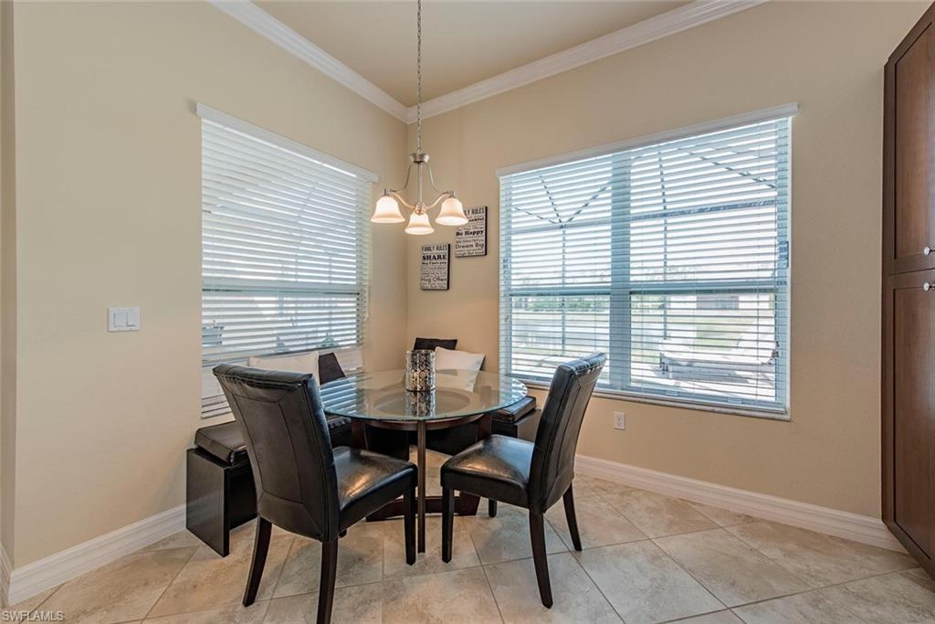 Dining area featuring ornamental molding and a chandelier