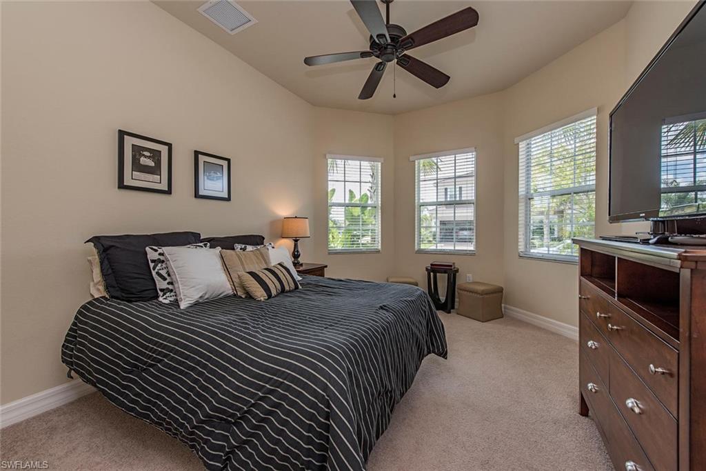 Bedroom featuring light colored carpet and a ceiling fan