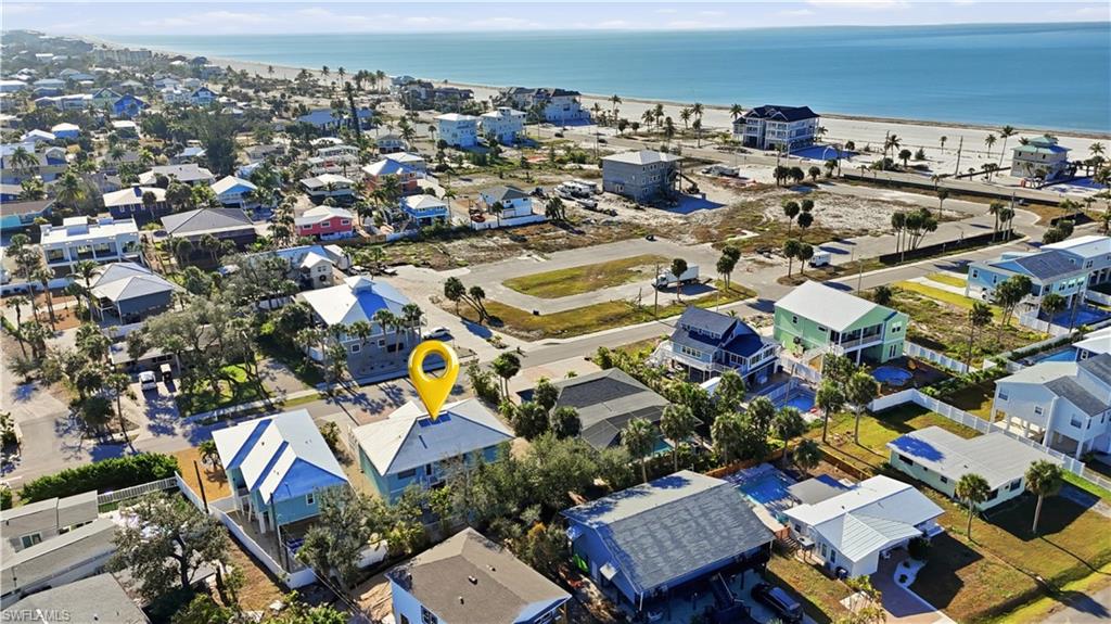 Aerial overview of property's location with nearby suburban area and a large body of water