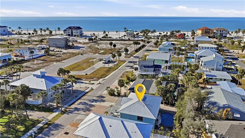 Aerial perspective of suburban area featuring a nearby body of water