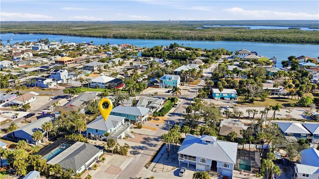 Aerial view of property's location with nearby suburban area and a large body of water