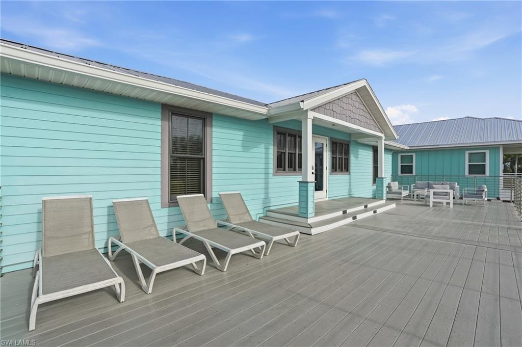 Wooden terrace featuring outdoor lounge area - Virtually Edited Image