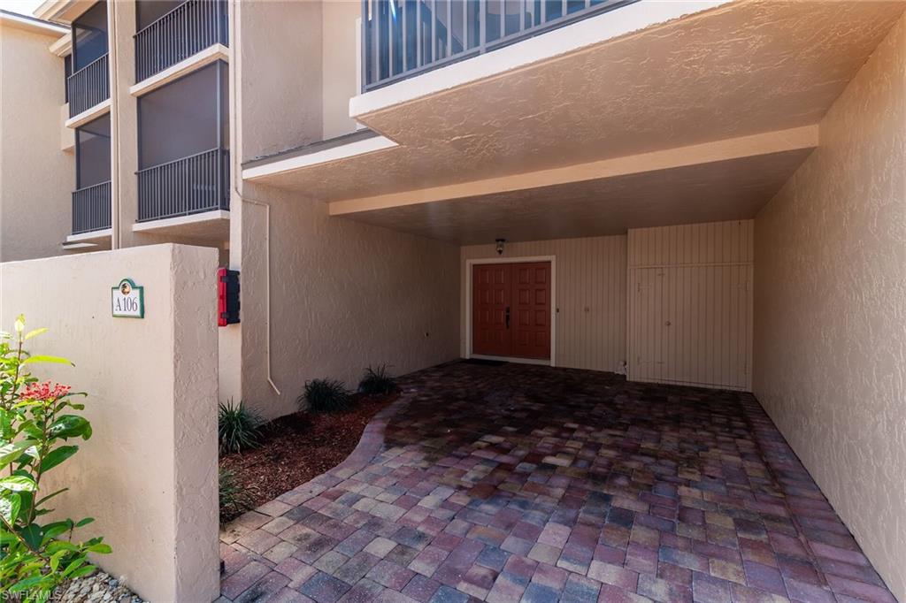 Doorway to property featuring stucco siding and a patio area