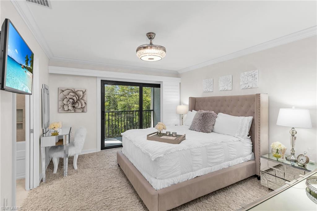 Carpeted bedroom featuring access to exterior and ornamental molding