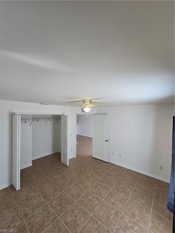 Unfurnished bedroom with a closet and ceiling fan