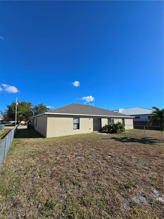 Rear view of property with stucco siding