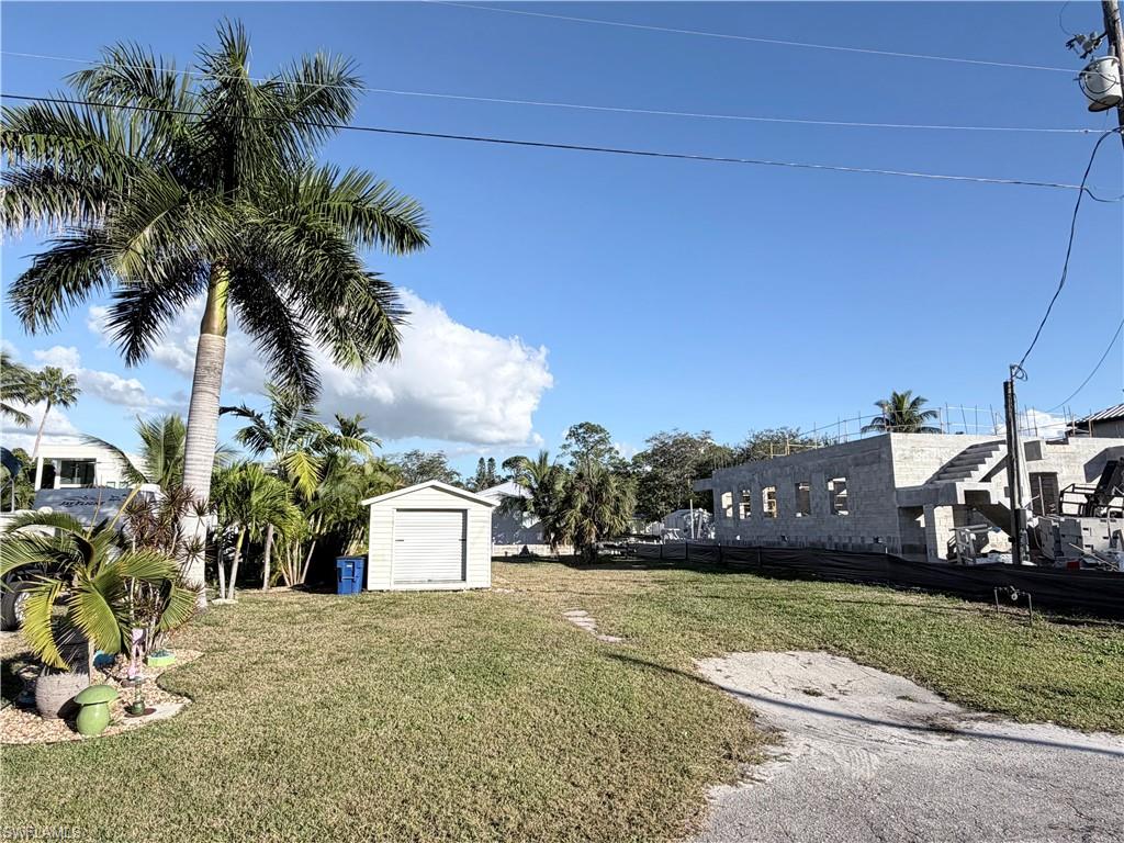 View of grassy yard with a shed