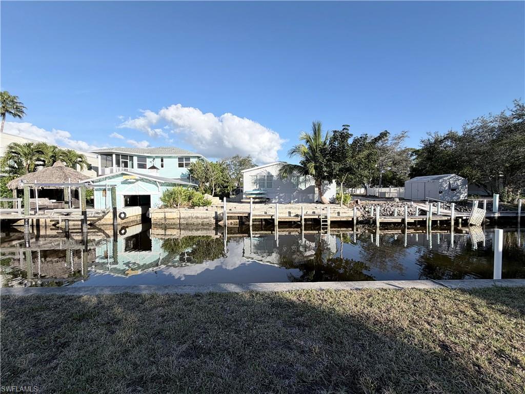 Dock area featuring a yard and a water view