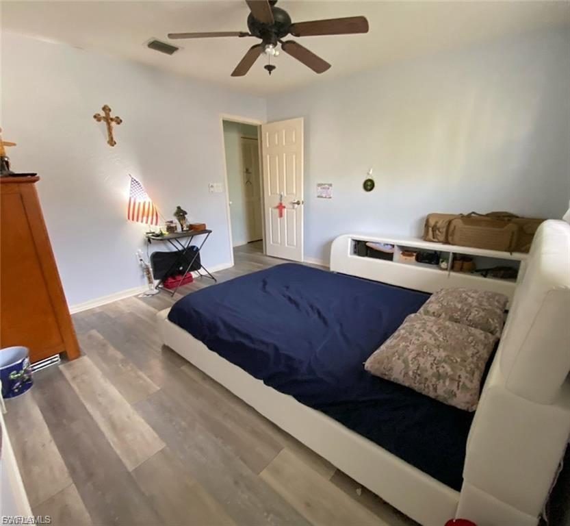 Bedroom with wood finished floors and ceiling fan