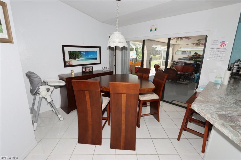 Dining room featuring light tile patterned flooring and lofted ceiling
