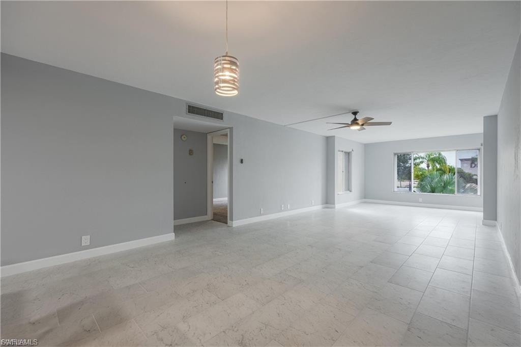 Spare room with light floors and ceiling fan