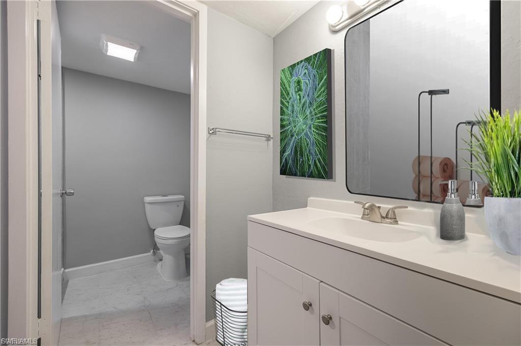 Bathroom with light marble finish floors and vanity