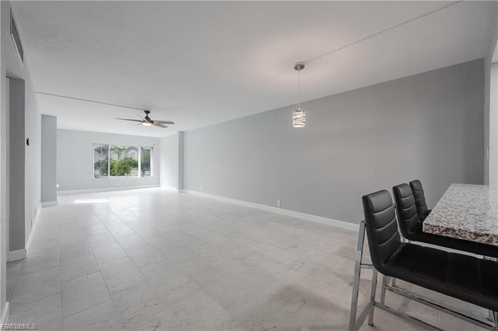 Dining space featuring baseboards and a ceiling fan