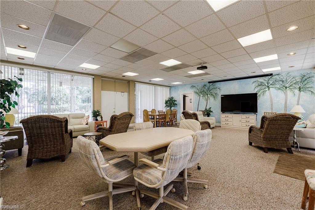 Dining space featuring carpet floors and a drop ceiling