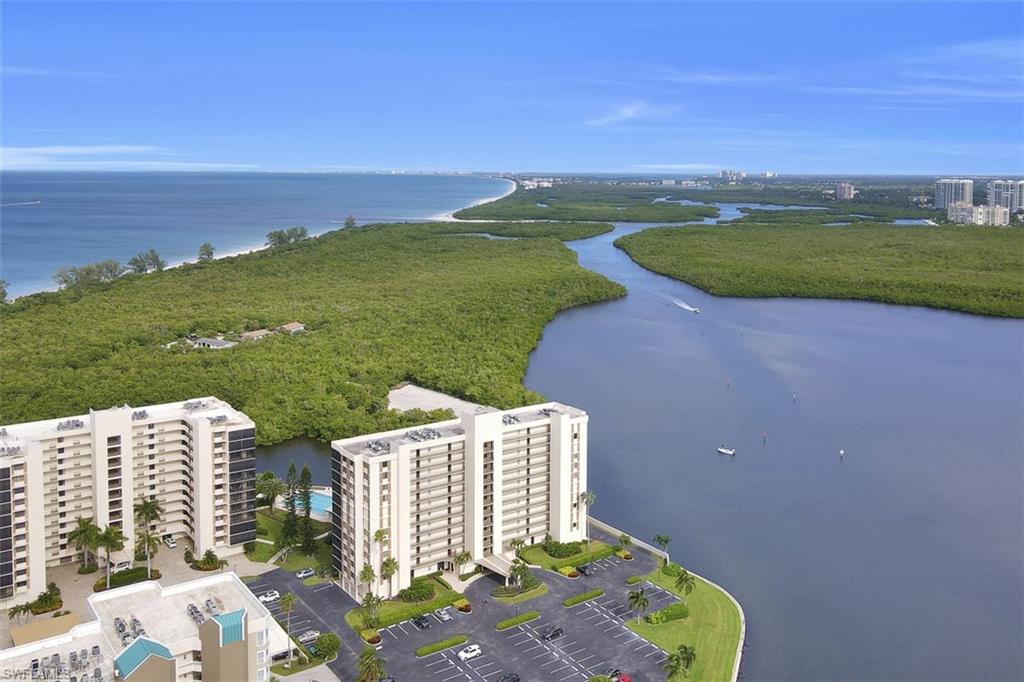Drone / aerial view of a large body of water and apartment complex