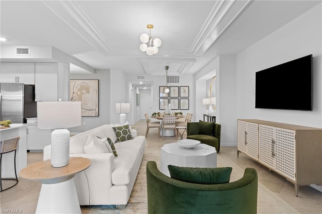 Living area featuring light tile patterned floors and a chandelier