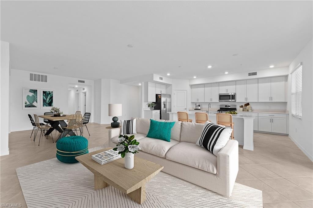 Living area with recessed lighting and light tile patterned flooring