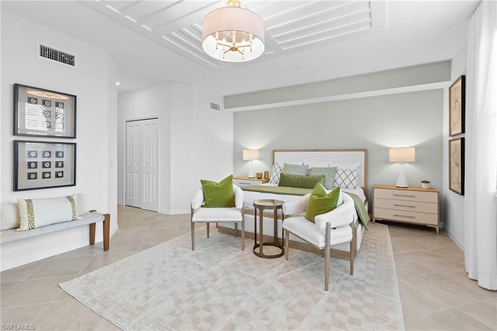 Bedroom featuring light tile patterned floors and a closet