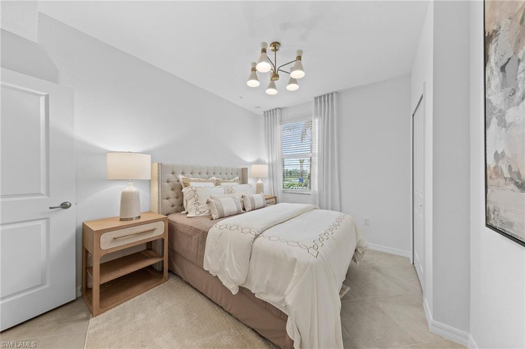 Bedroom featuring a chandelier and light tile patterned floors