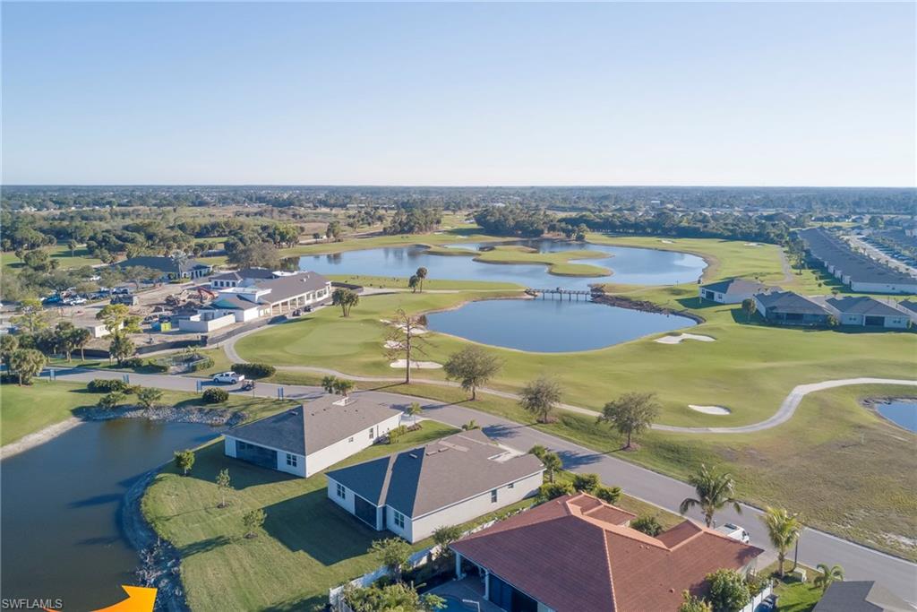 Aerial view of residential area with a local golf course and a large body of water
