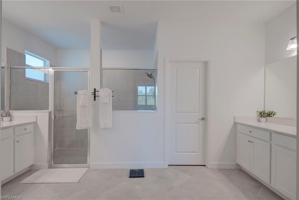 Full bathroom featuring vanity and a stall shower