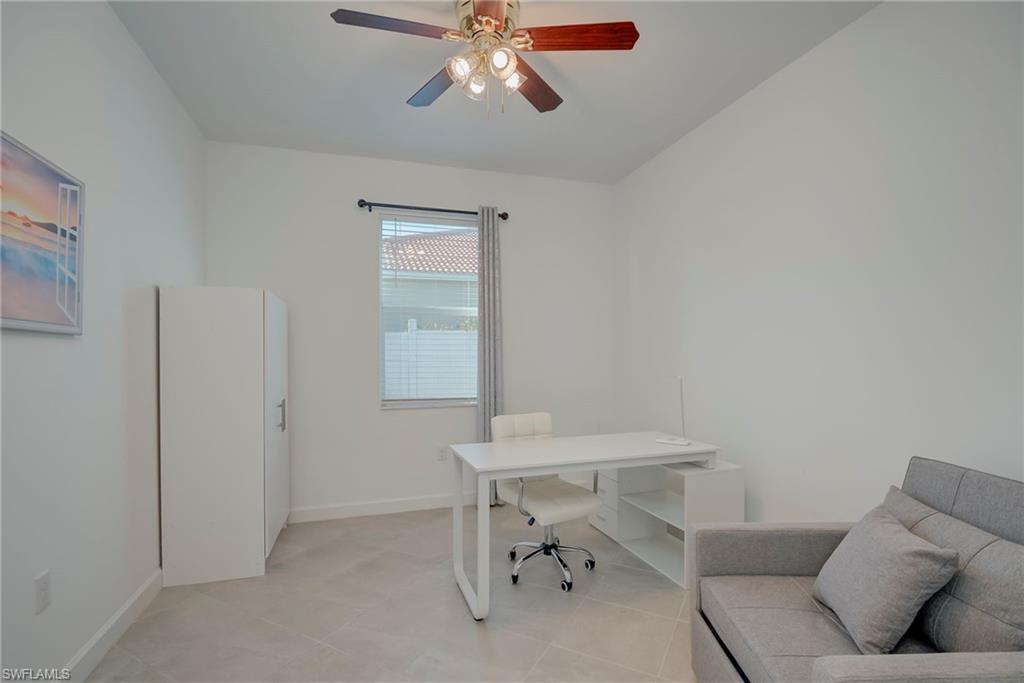 Home office featuring baseboards and ceiling fan
