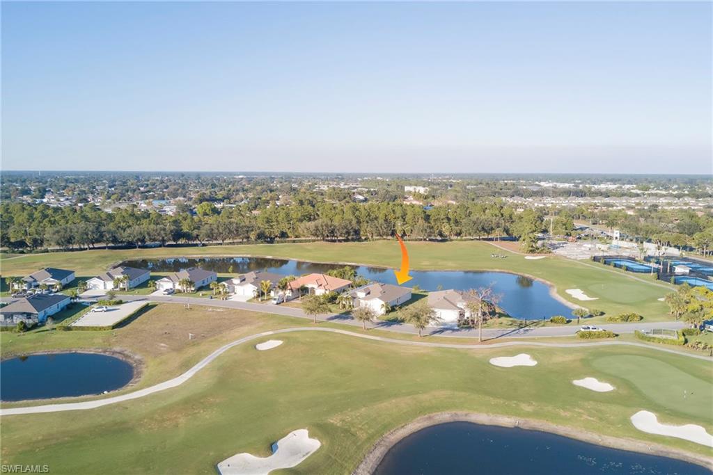 Aerial overview of property's location with a local golf course and nearby suburban area