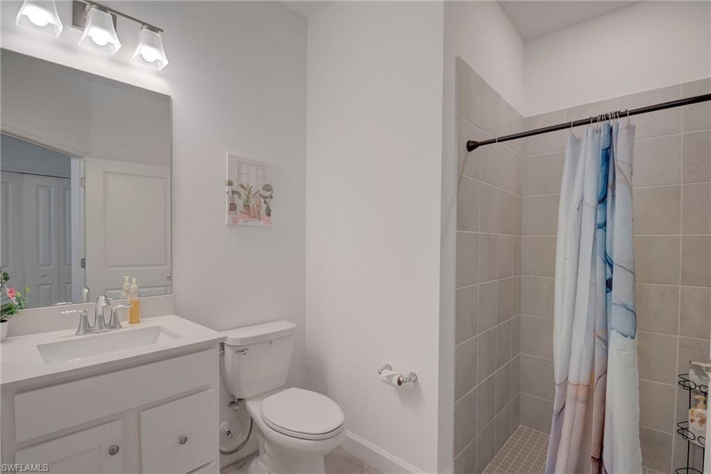 Bathroom featuring vanity and a shower stall