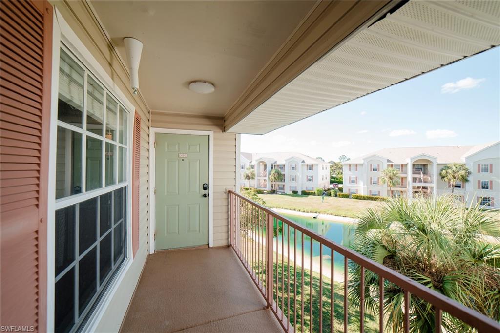 Balcony featuring a water view and front door