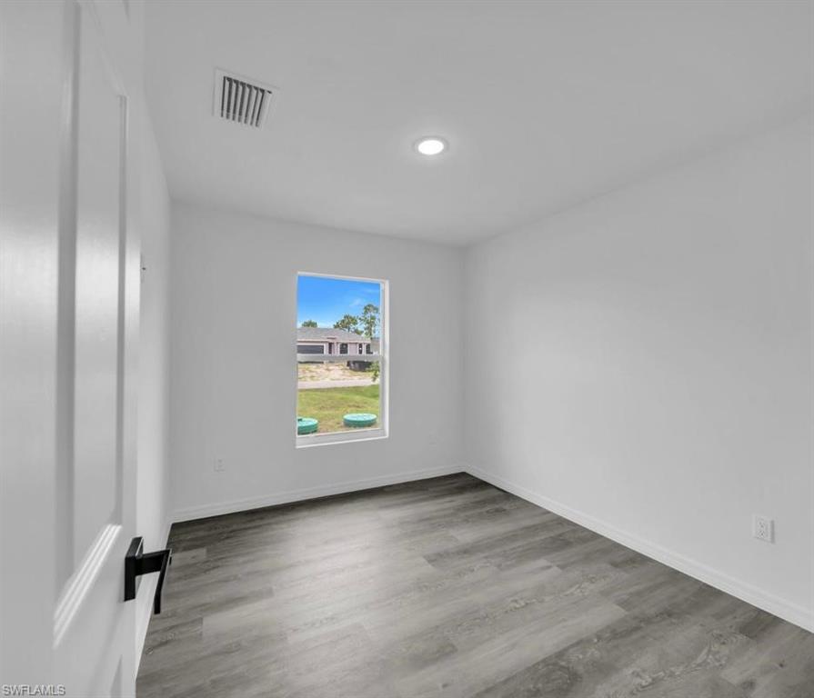 Empty room featuring light wood-style flooring and baseboards
