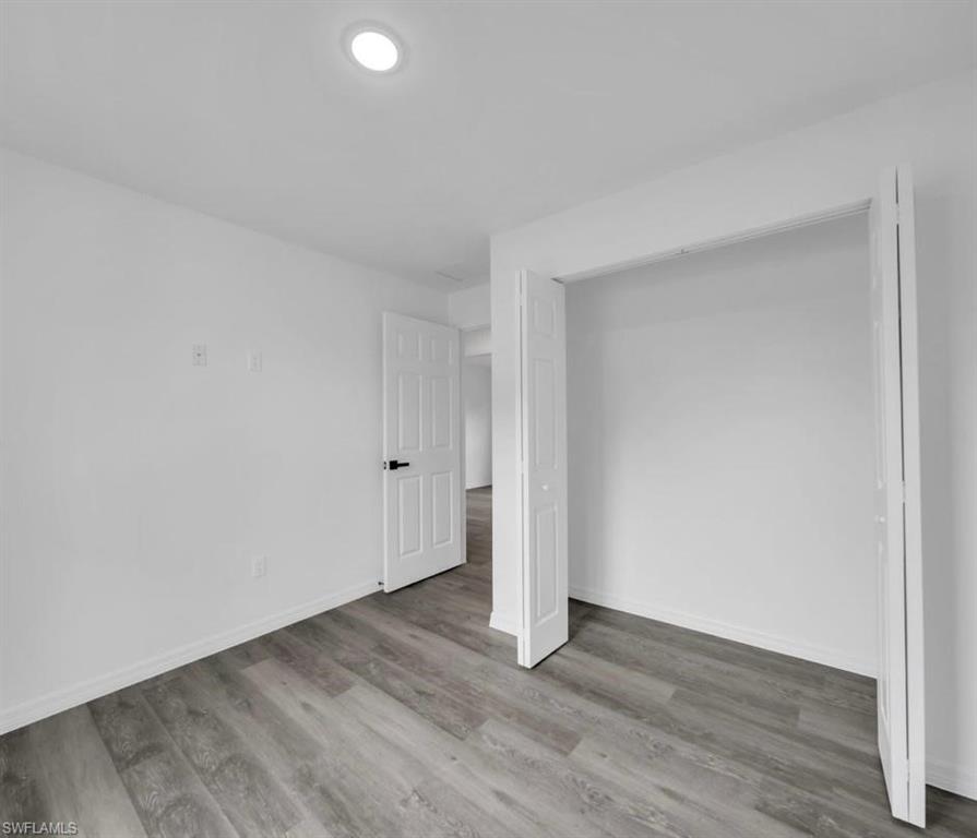 Unfurnished bedroom featuring light wood finished floors and a closet