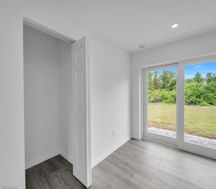 Empty room with wood finished floors and recessed lighting