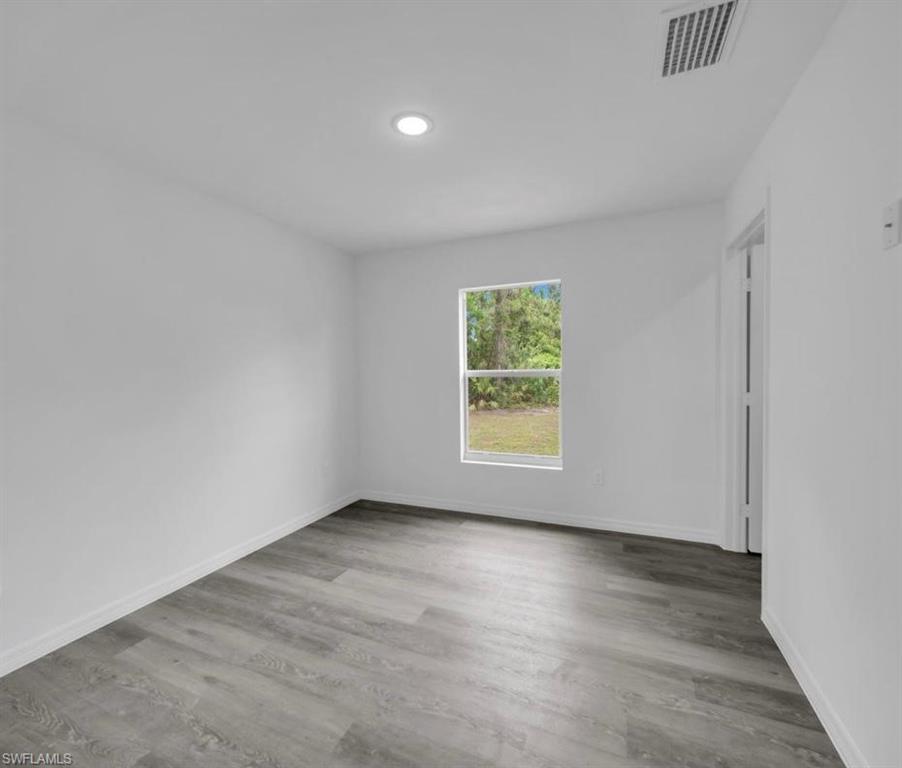 Empty room with light wood finished floors and baseboards