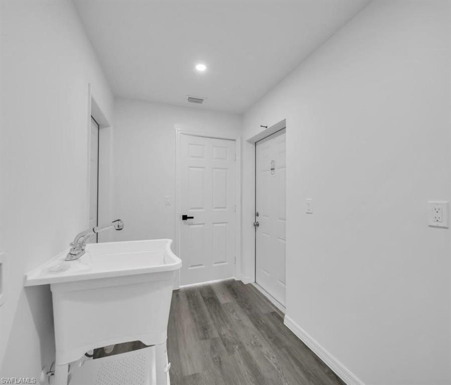 Bathroom with wood finished floors and recessed lighting