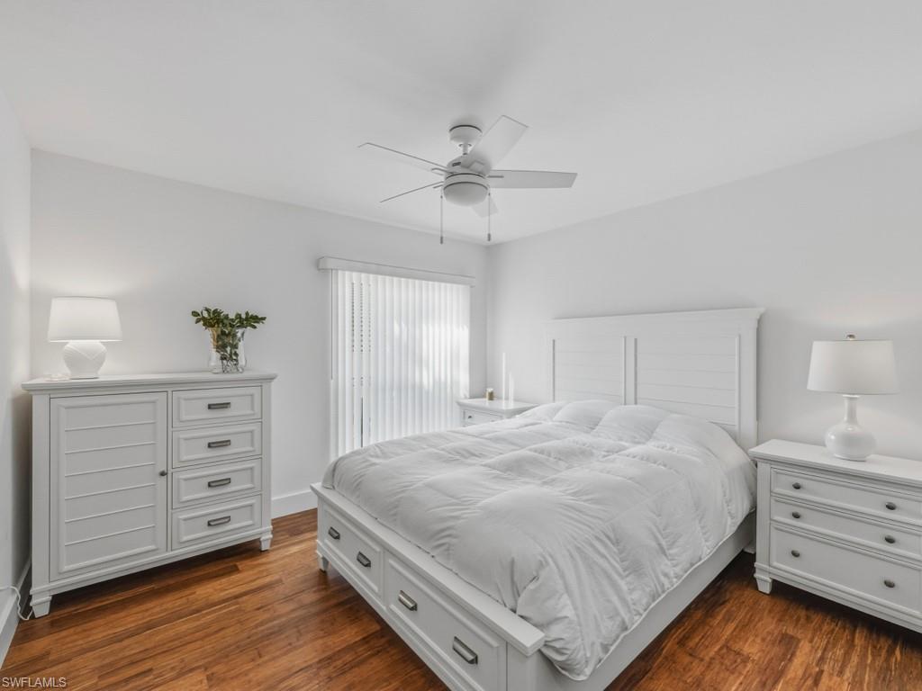 Bedroom featuring dark wood-style flooring and a ceiling fan