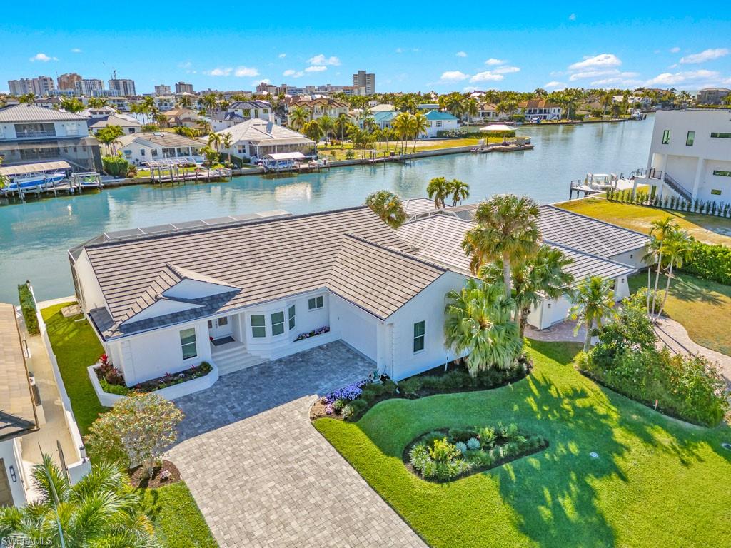 Aerial perspective of suburban area featuring a nearby body of water