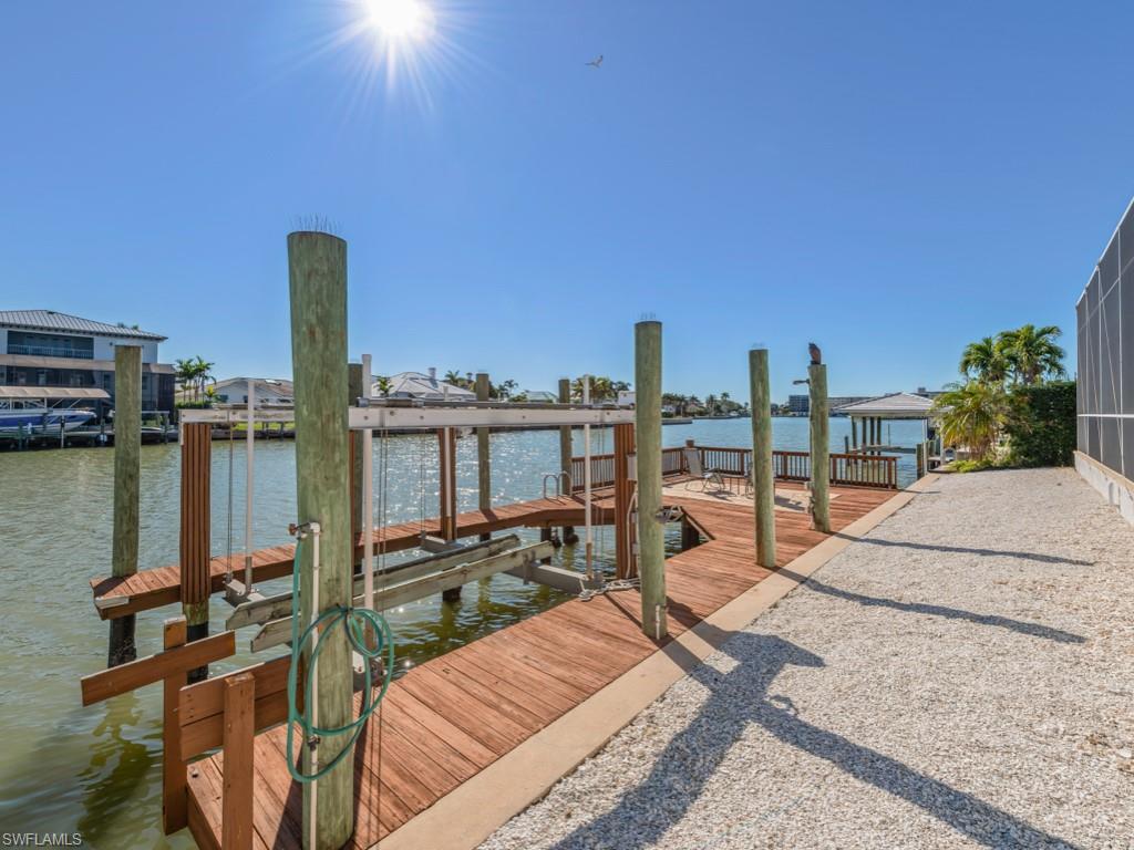 Dock with boat lift and a water view