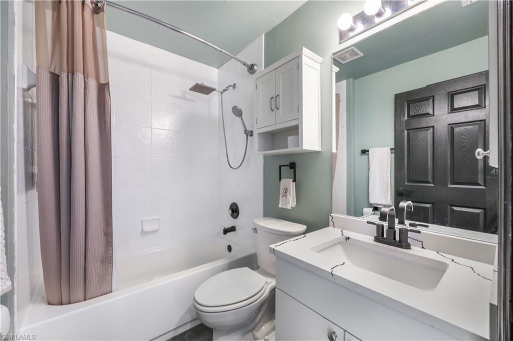 Bathroom featuring shower / bath combo and vanity