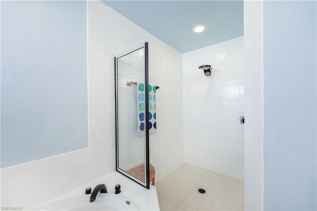 Bathroom featuring a bath and tiled shower