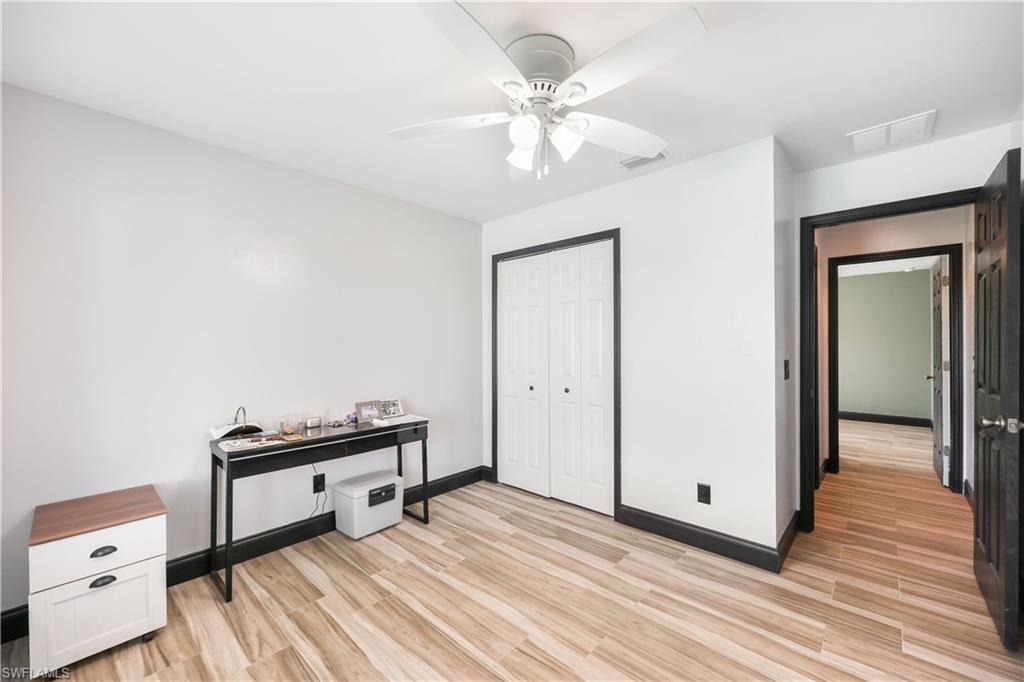 Bedroom featuring a closet, light wood-style floors, and a ceiling fan