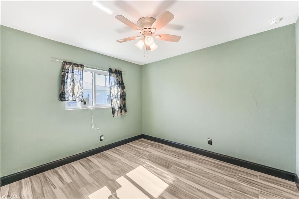 Unfurnished room featuring wood finished floors and ceiling fan