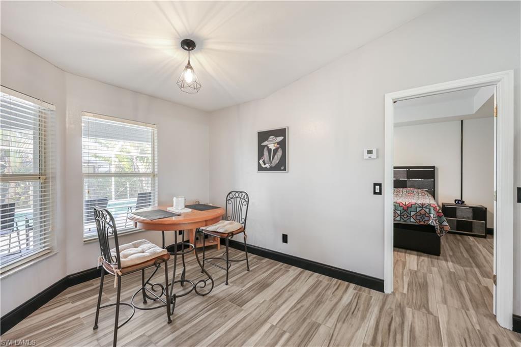 Dining area featuring light wood-style floors and baseboards